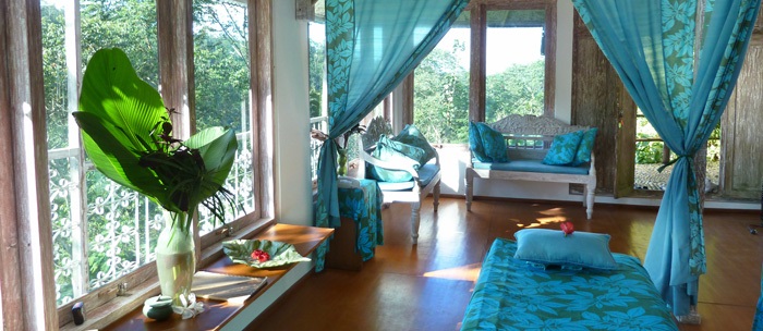 Photo of spa interior, showing chairs and a bed